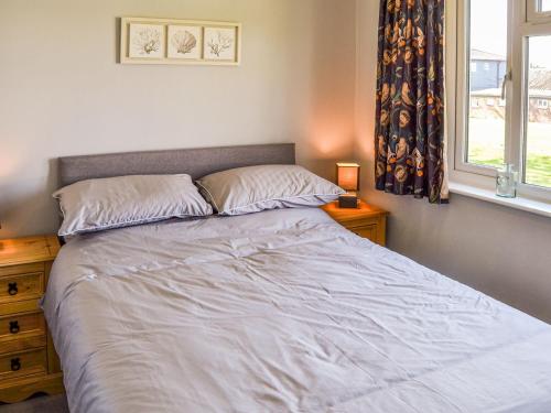 a bedroom with a large bed with a window at Meadow Crest in Belton