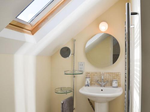 a bathroom with a sink and a mirror at Newcombe Cottage in Flamborough