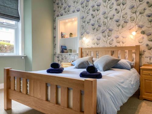 a bedroom with a large bed with two teddy bears on it at Hollybank in Ladybank