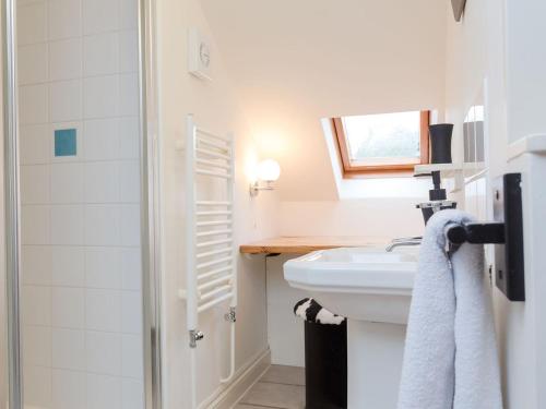 uma casa de banho branca com um lavatório e um chuveiro em Deco-uk12749 em Menheniot