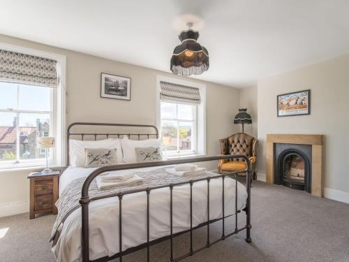 a bedroom with a bed and a fireplace at Edenholme in Robin Hood's Bay