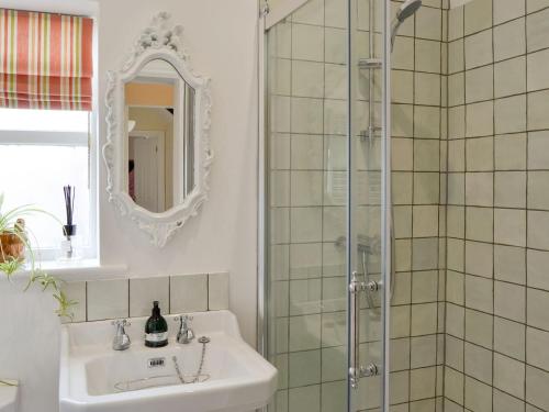 a bathroom with a sink and a shower at The Coach House in Great Ryburgh