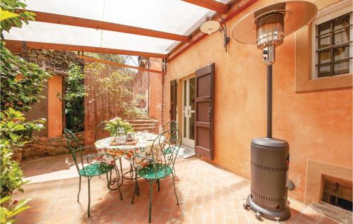 a patio with a table and chairs and a heater at Casa I Gelsi in Tre Colli
