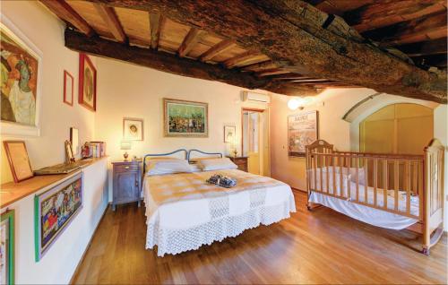 a bedroom with a bed and a crib in it at Casa I Gelsi in Tre Colli