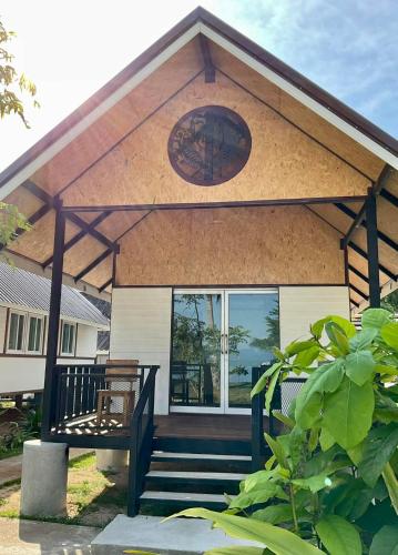 a house with a porch with a bench on it at Sunrise House in Ko Yao Noi
