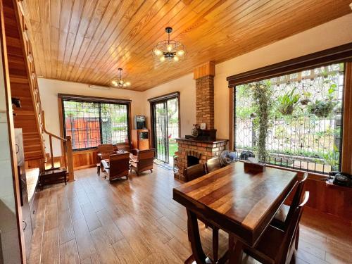 a living room with a wooden ceiling and a table at Nhà An Cozy in Da Lat