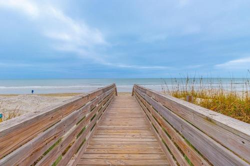 a wooden boardwalk leading to the beach at Seaward Escape - Cherry Grove Beach in Myrtle Beach