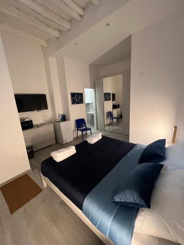 a large bedroom with a large bed with blue pillows at LB Home in Termini Imerese