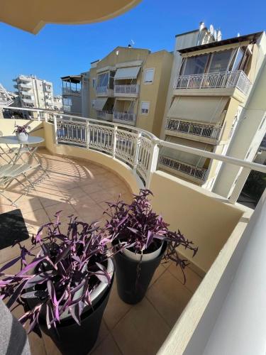 two potted plants on the balcony of a building at Evelyn's Apartment in Alexandroupoli