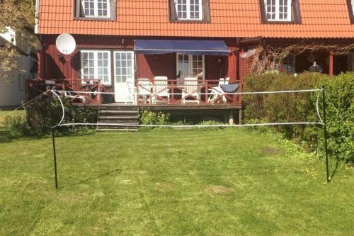 a yard with a volleyball net in front of a house at Entire Town House on Ground floor front of Lake in Märsta
