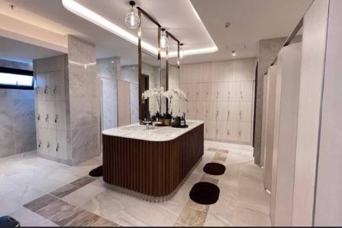 a bathroom with a sink and a large mirror at Modern style room with sky pool 古城边天际泳池公寓 in Chiang Mai