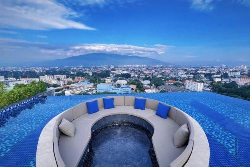 a swimming pool with a view of a city at Modern style room with sky pool 古城边天际泳池公寓 in Chiang Mai