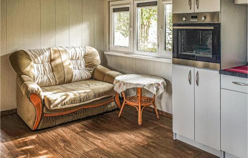 a living room with a couch and a table at Awesome Home In Biskupiec With 2 Bedrooms in Biskupiec