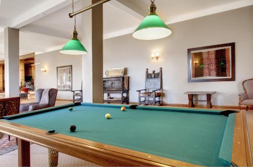 a living room with a pool table at Hotel Tres Reyes in San Carlos de Bariloche