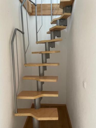 a spiral staircase in a room with wooden steps at Ferienhaus Groß Grönau in Groß Grönau