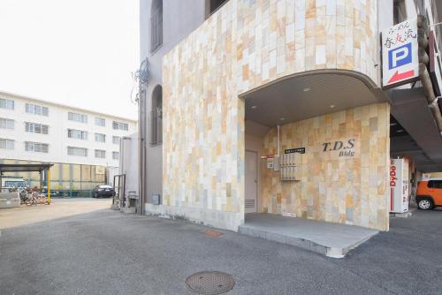 a building with a sign on the side of it at Comfy Stay TDS in Nara