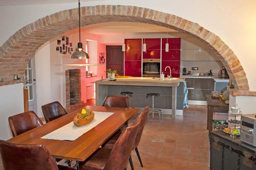 a kitchen and dining room with a table and chairs at Cascina IL SOGNO in Cossano Belbo