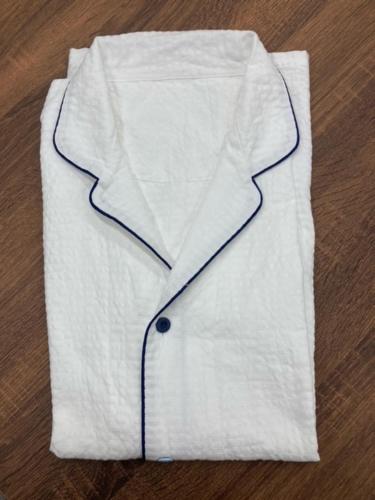 a white jacket sitting on top of a wooden floor at HOTEL Gran Arenaホテルグランアリーナ in Okinawa City