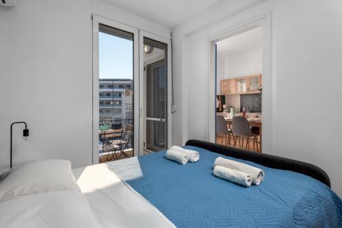 a bedroom with a bed with two towels on it at Rhodes Central Apartment in Rhodes Town