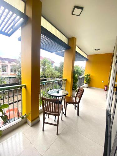 a patio with two chairs and a table on a balcony at HOIANIAN CENTRAL VILLA in Hoi An