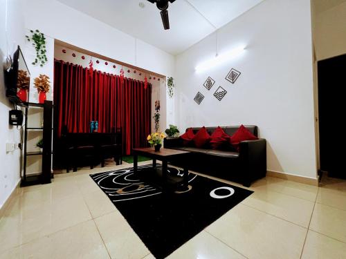 a living room with a couch and a table at Mesmerizing comfy condo with world class amenities in Manipala