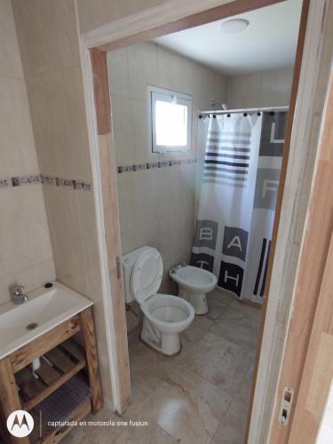 a bathroom with a toilet and a sink at Los nogales in Tandil