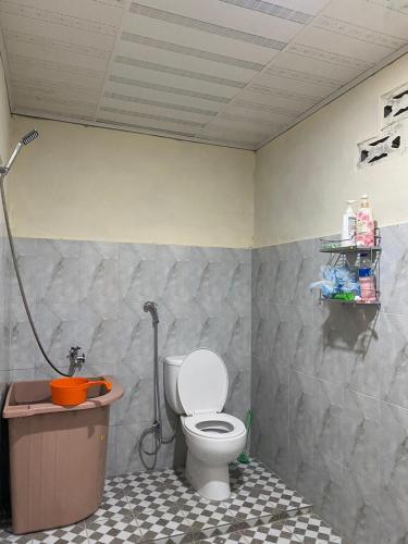 a bathroom with a toilet and a shower at Paima Homestay in Laguboti
