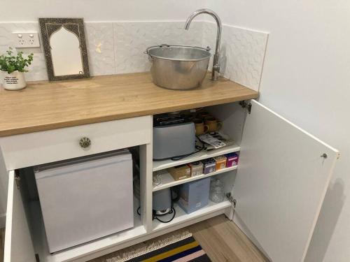 a small kitchen with a counter with a sink at Blue Heart Studio Apartment in Willunga