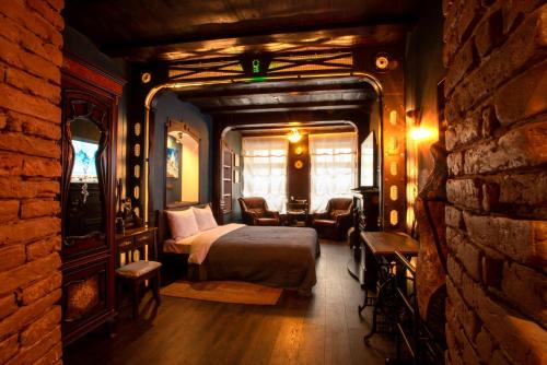 a bedroom with a bed and a brick wall at Quarter (25) in Lviv