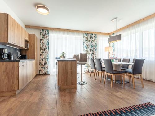 a kitchen and dining room with a table and chairs at Beautiful chalet in St Lambrecht with infrared sauna in Sankt Lambrecht