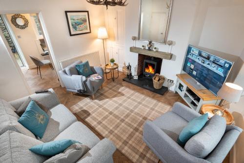 an overhead view of a living room with a fireplace at Woodland Cottage - cosy dog friendly cottage in the heart of Windermere in Windermere