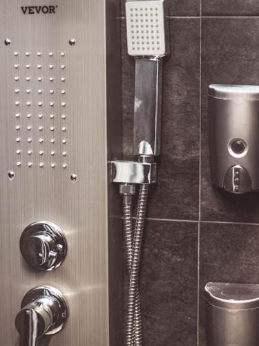 a shower in a bathroom with a phone on the wall at MODERN FLAT POBLE NOU in Barcelona