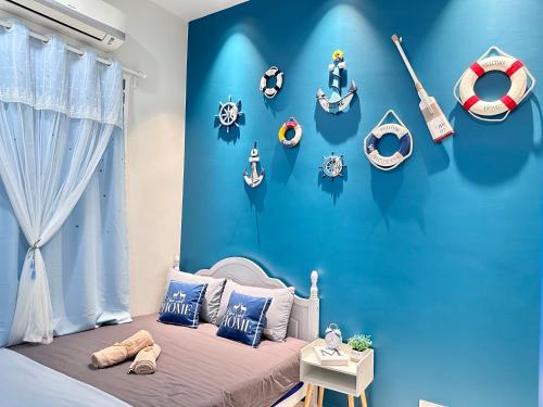 a childs room with a blue wall with a bed at The Blue Memories Homestay (Mediterranean Style) in Sungai Pelik