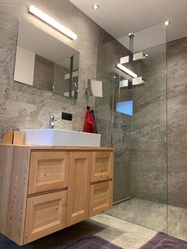 a bathroom with a sink and a shower at WALD-Apart am Rosenhof in Nauders