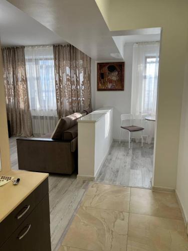 a living room with a couch and a table at Apartament27 in Almaty
