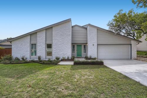 a house with a green door and a garage at Cozy Stylish Home in Round Rock! in Round Rock