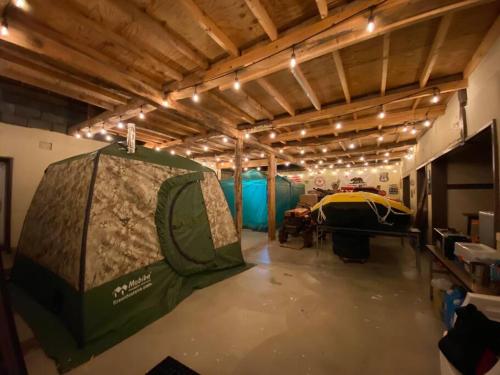 a room with a tent in the middle of it at Yadoya YADOKARI in Pippu