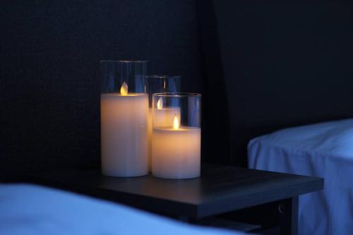 two candles sitting on a table in a room at Yadoya YADOKARI in Pippu