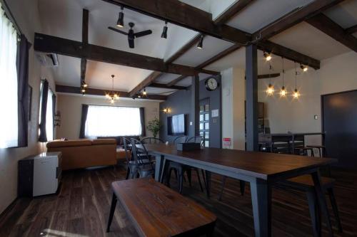a large room with a table and a couch at Yadoya YADOKARI in Pippu