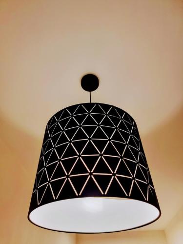 a black and white pendant light hanging from a ceiling at Jaffa 17 - Lihi brand new studio in Jerusalem