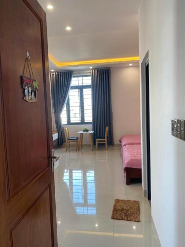 a room with a bed and a room with a door at VIVU HOMESTAY VUNG TAU in Vung Tau