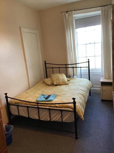 a bed in a bedroom with a window at Sea View Guest House in Hartlepool