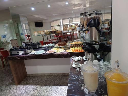 a buffet with food and drinks on a table at Serra Linda Hotel in Serra