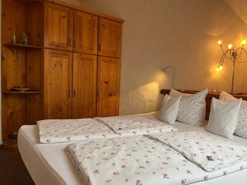 a bedroom with two beds with white sheets at NaturApartments - Hideaway & Spa in Burg