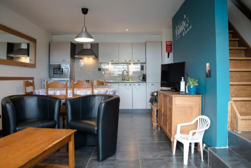 a dining room and kitchen with a table and chairs at Belle vue in Malmedy