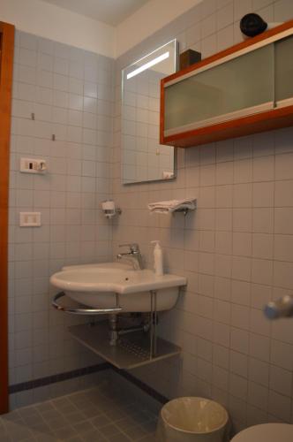 a bathroom with a sink and a mirror at DOMUS B Corso Francia apartment in Rome