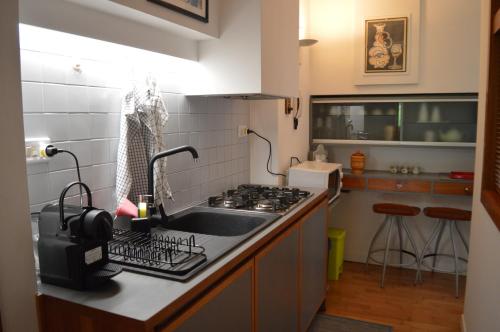 a kitchen with a sink and a stove at DOMUS B Corso Francia apartment in Rome
