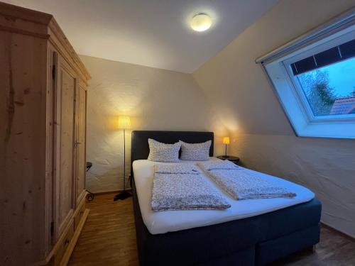 a bedroom with a large bed with a window at NaturApartments - Hideaway & Spa in Burg
