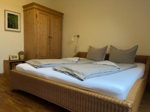 a bed with two pillows on it in a room at NaturApartments - Hideaway & Spa in Burg