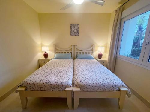 a bedroom with a bed and a window at Casa de la Suerte in Almuñécar